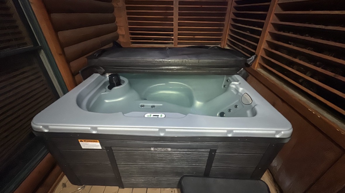 Hot tub with the cover open during a spa inspection